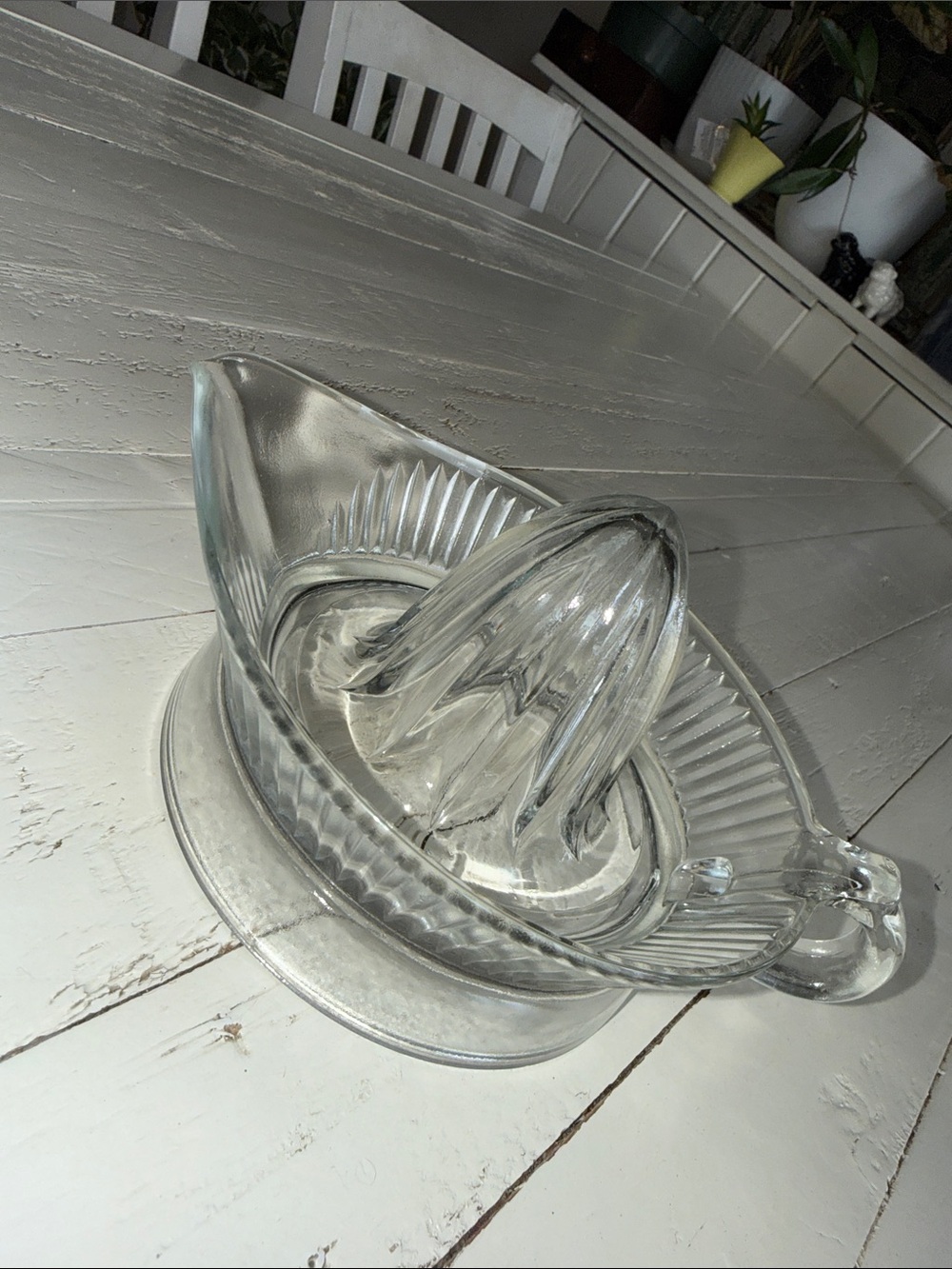 vintage-style clear glass citrus juicer, commonly known as a citrus reamer